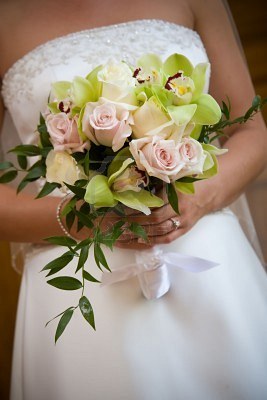 Essex Toastmaster admires beautiful rose and orchid wedding bouquet