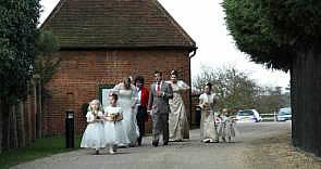 Essex Lady Toastmaster holding Wedding Dress as the Bride leaves the Honeymoon cottage on way to Wedding Ceremony at Gaynes Park, Essex,  photograph courtesy of Divine Photography,