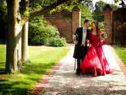 Groom with Bride in Red Dress at Gaynes Park at wedding day co-ordinated by Essex MC and Lady Toastmaster, Linda Palmer
